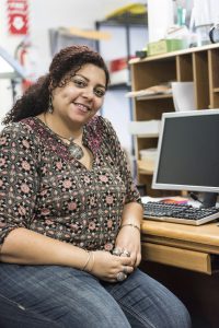 Smiling hispanic mid adult female secretary